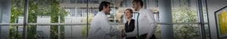 Three healthcare professionals discussing value-based care.
