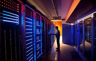 Man standing in back tech room