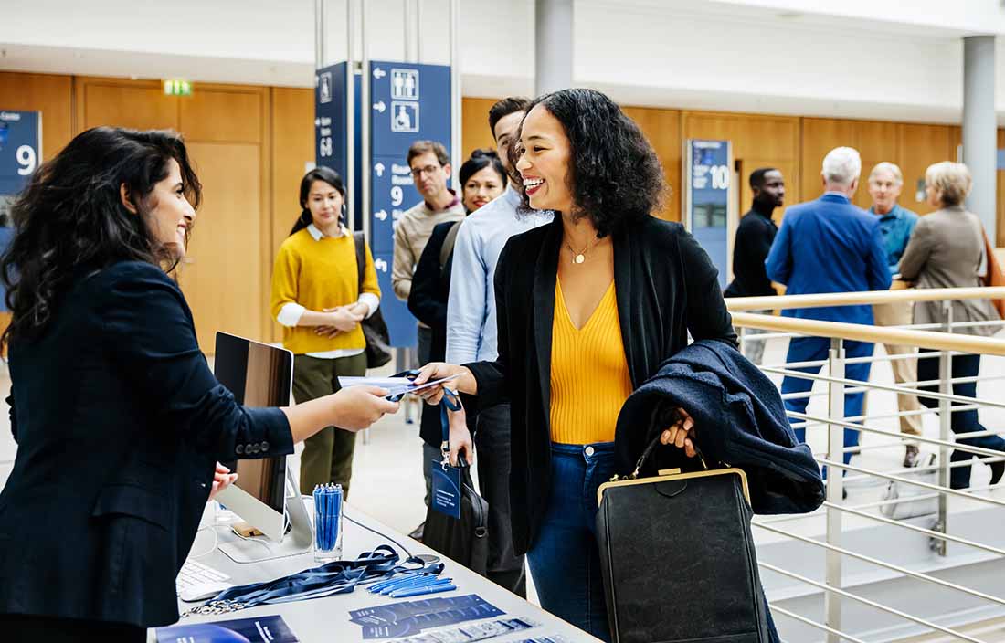Business professional visiting a booth at the Plastics News Executive Forum.