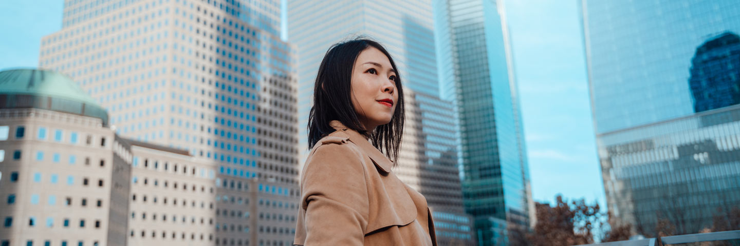 Person looking to the distance in the middle of a city.