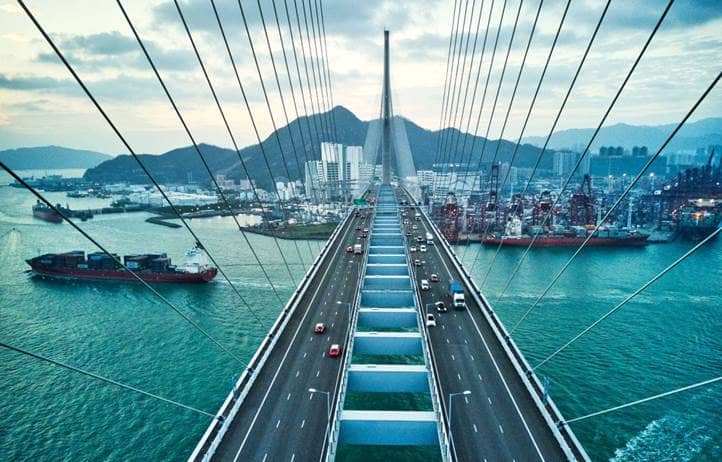 Aerial view of bridge and ships crossing.
