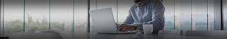Business professional using a laptop computer to check Plante Moran Webinar FAQs.