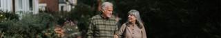 Two senior citizens walking together.