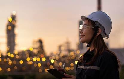 Construction worker in hard hat looking out to the skyline.