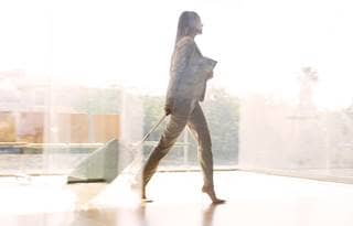Person walking with documents 