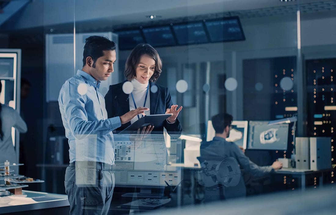 Two business professionals reviewing information together on a tablet device.
