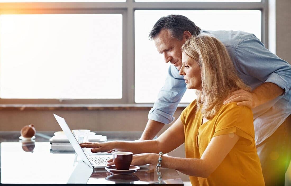 A couple reviewing life insurance annuities on their laptop computer