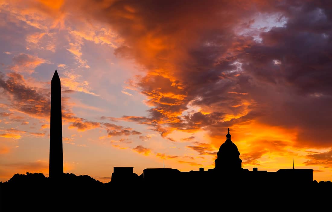 Washington D.C. skyline against a cloudy sunset.