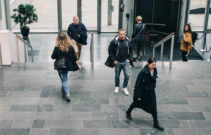 Businesspeople walking in an office building.