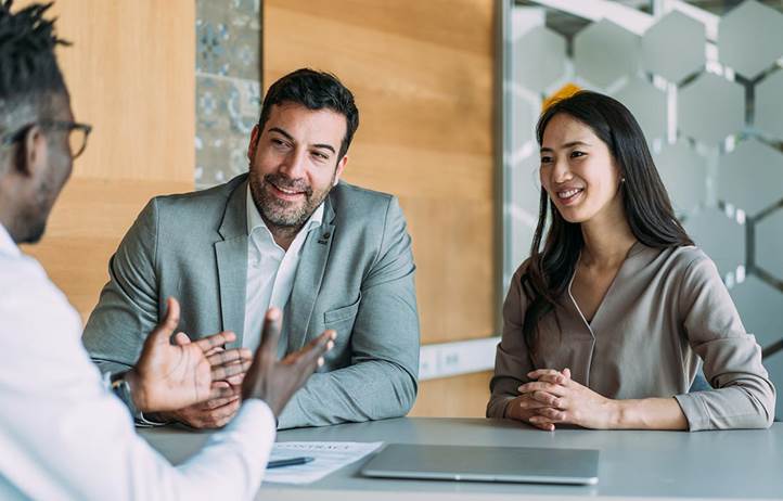 Couple talking to their financial advisor.