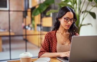 Employee benefit professional working on their laptop.