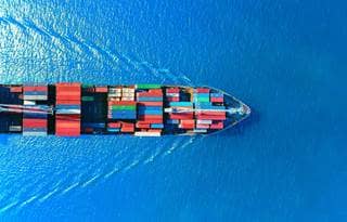Cargo ship sailing through the ocean.