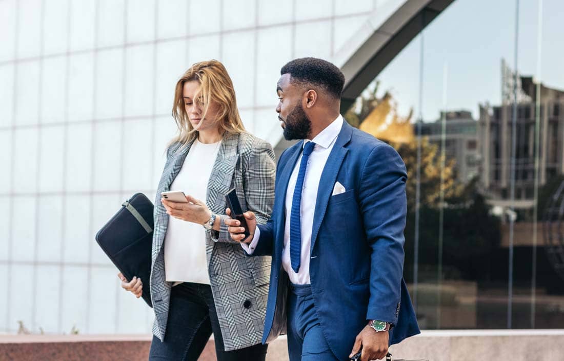 Business professionals walking and discussing Form 5500.