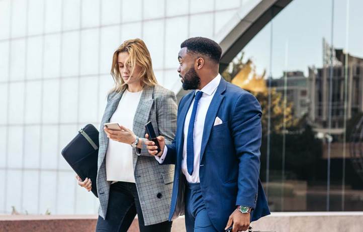 Business professionals walking and discussing Form 5500.