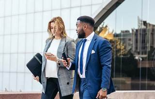 Business professionals walking and discussing Form 5500.