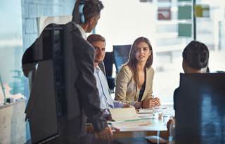 Business professionals meeting in a modern conference room.