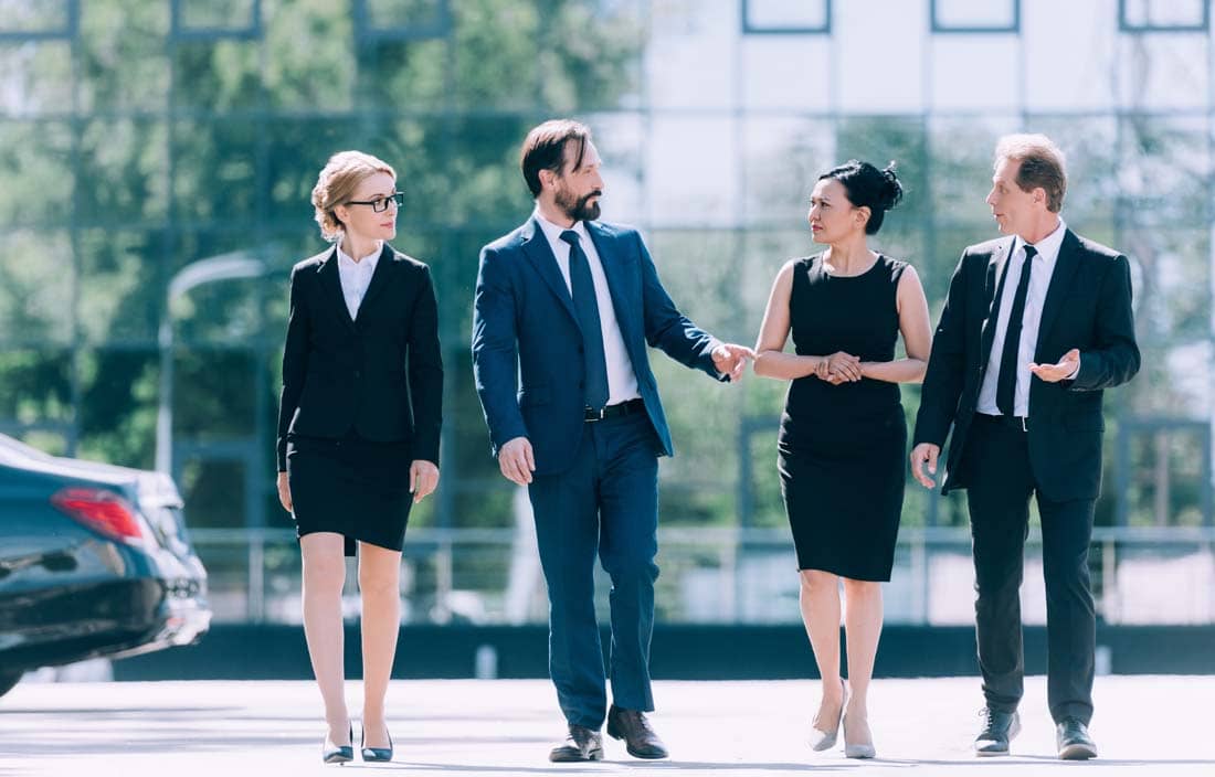 Group of business professionals walking and talking after a meeting.