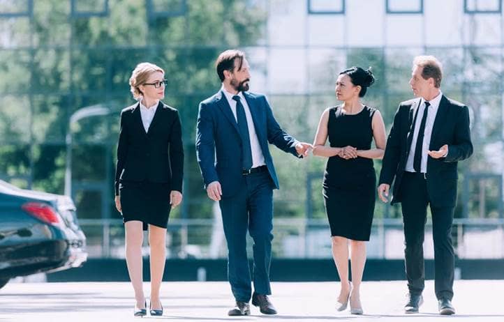 Group of business professionals walking and talking after a meeting.