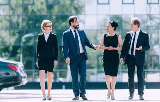 Group of business professionals walking and talking after a meeting.