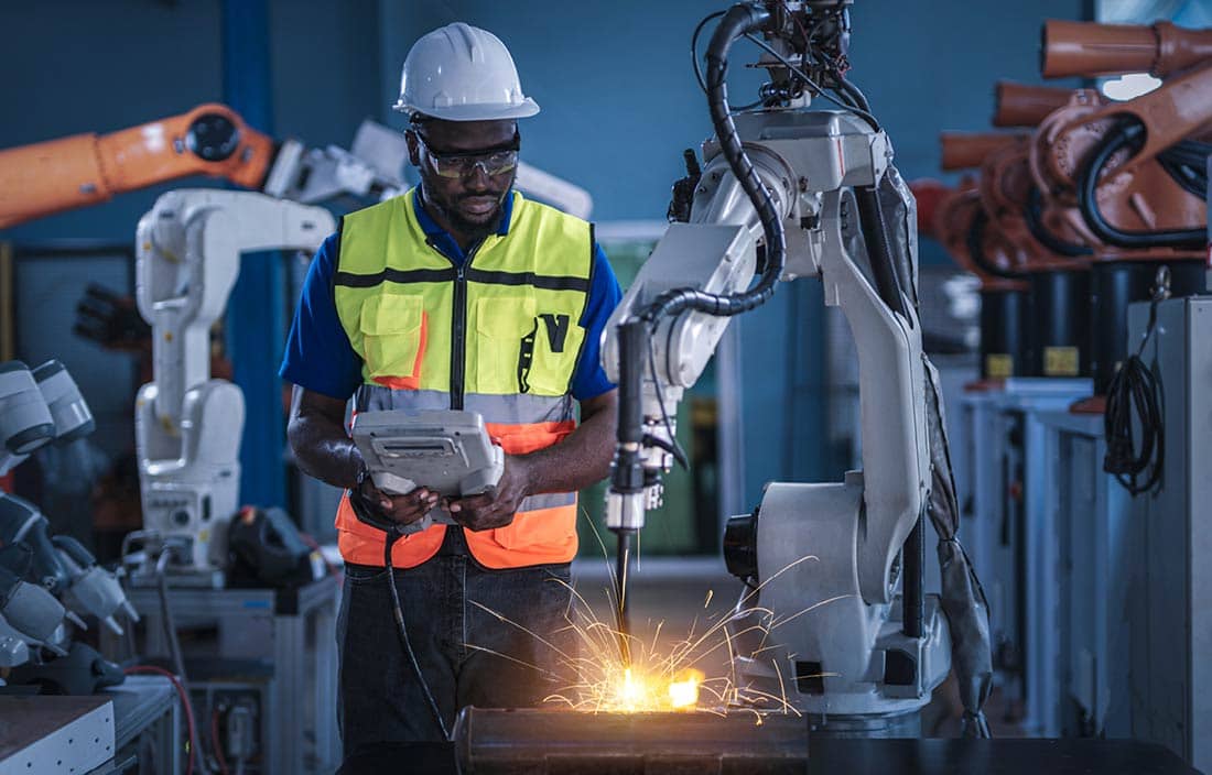 Manufacturer in a hi-vis vest working in a factory.