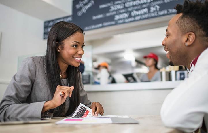 Two franchise owners talking to each other about tax planning.