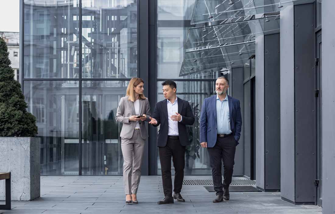 Employee benefits professionals walking outside of an office.