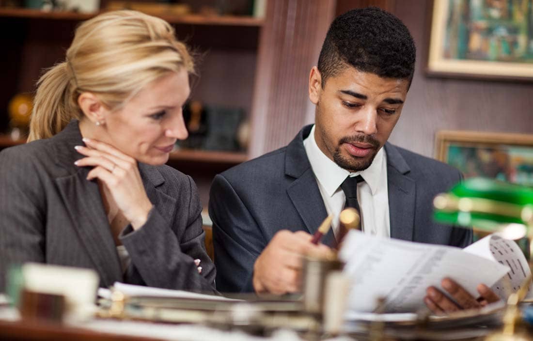 Retirement plan professionals reviewing documents.