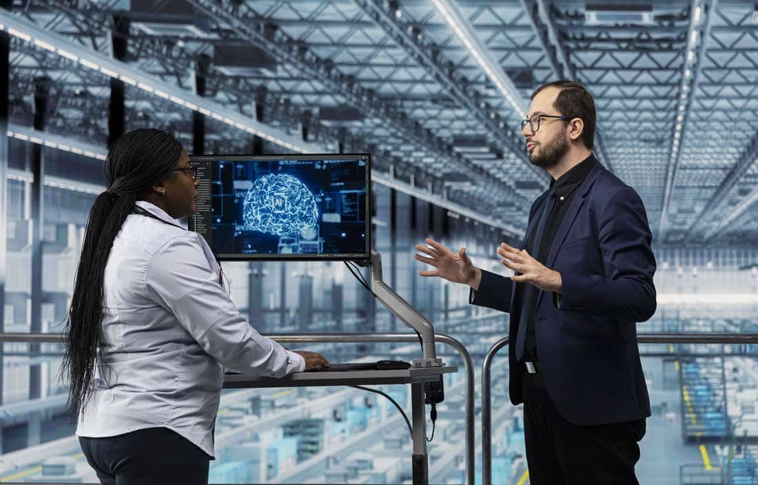 Manufacturing professionals discussing AI in a factory.