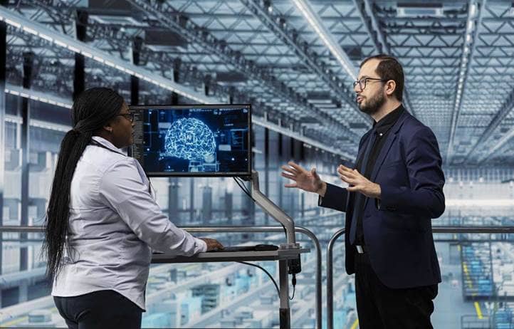 Manufacturing professionals discussing AI in a factory.