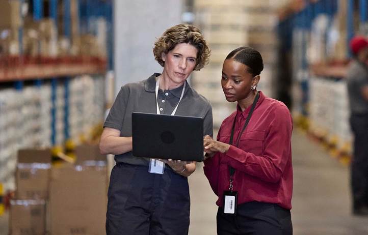 Manufacturers reviewing inventory in a factory.
