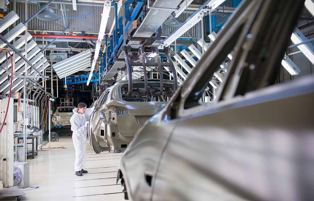 Auto worker in an automotive factory.