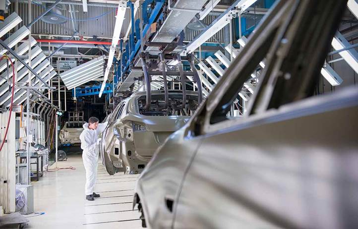 Auto worker in an automotive factory.