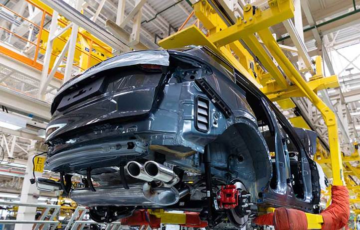 Automobile being assembled in a factory.