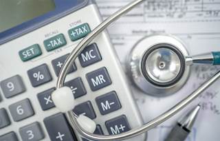 Close-up photo of a stethoscope and calculator