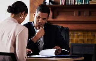 Employee benefits consultants reviewing a benefit plan.