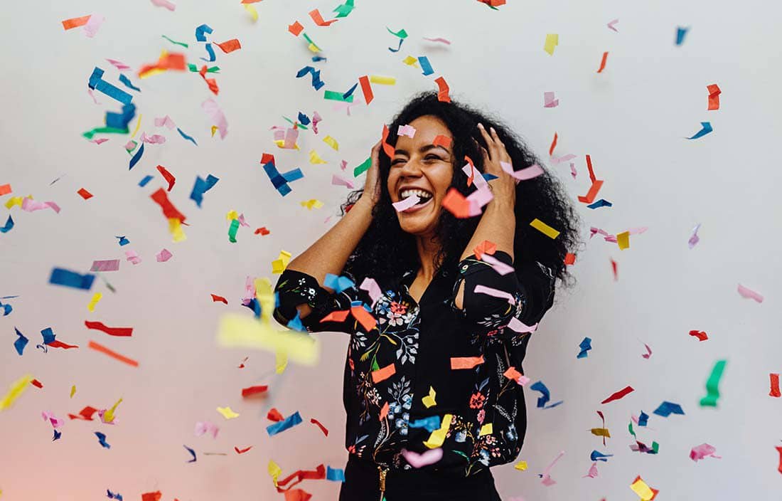 Woman celebrating with confetti.