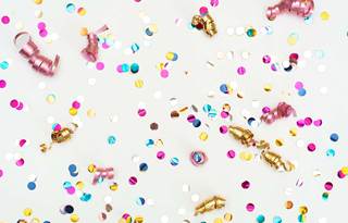 A close up of celebration confetti with a white background