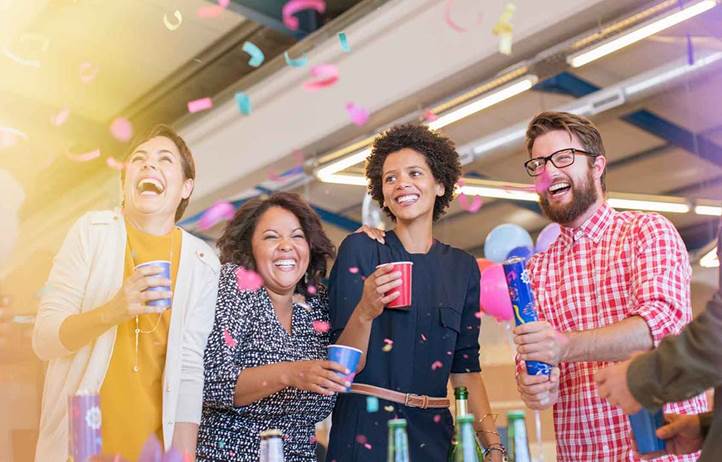 Coworkers celebrating with confetti.