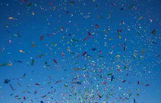 Colorful confetti on a dark blue background.