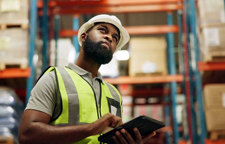 Warehouse worker doing inventory on a tablet