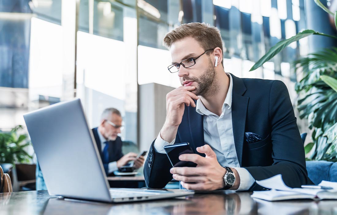 Man in an office looking at a computer screen.